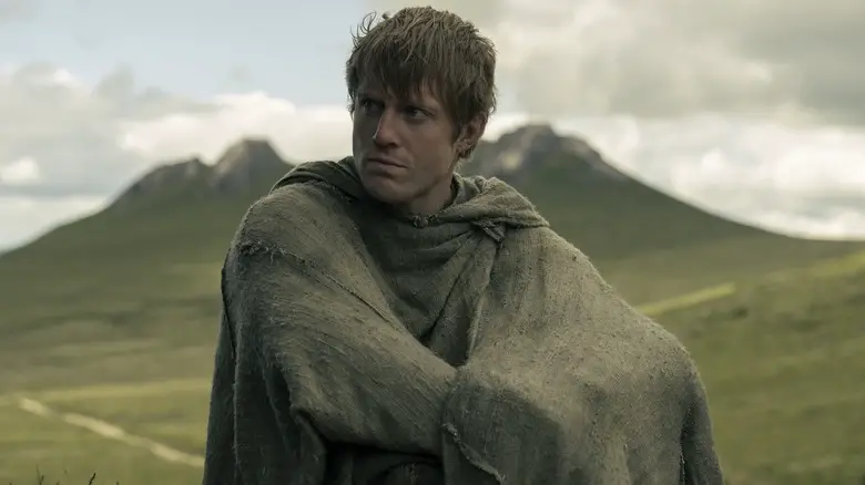 Peter Claffey as Ser Duncan the Tall sitting wrapped in his cloak in A Knight of the Seven Kingdoms