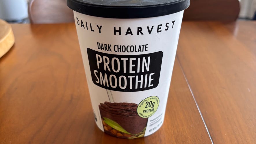 Daily Harvest Dark Chocolate Protein Smoothie on wood table.