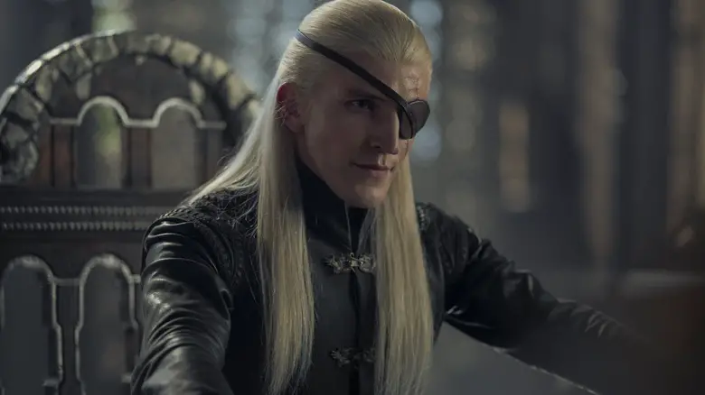 Ewan Mitchell as Aemond sitting at the small council room in House of the Dragon