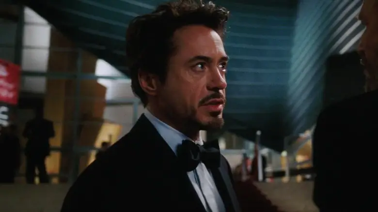 Robert Downey Jr's Tony Stark stands weark a tuxedo in Iron Man