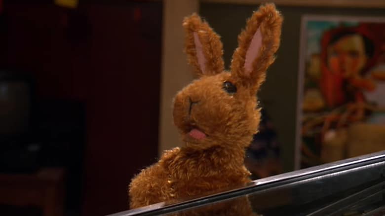 Greg leaning on a pinball machine in Greg the Bunny