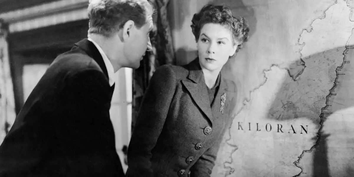 Wendy Hiller as Joan Webster and Roger Livesly as Toquill MacNeill standing in front of a map in I know Where I'm Going