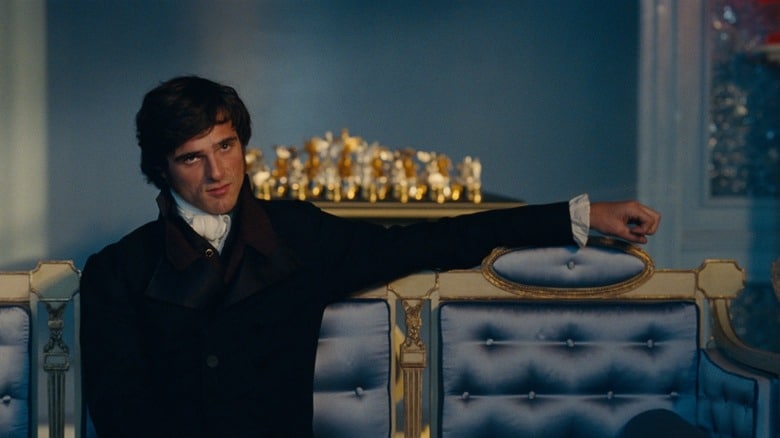 Heathcliff on a couch in a nice coat in Wuthering Heights