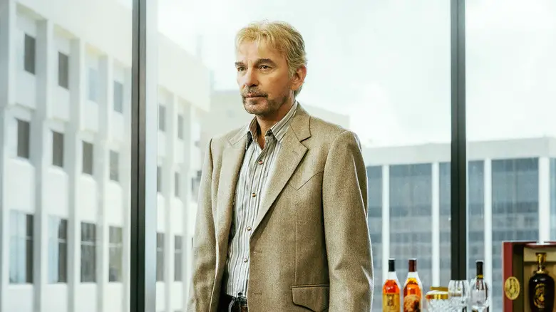 Billy Bob Thornton's Tommy Norris stands in an office by a window in Landman