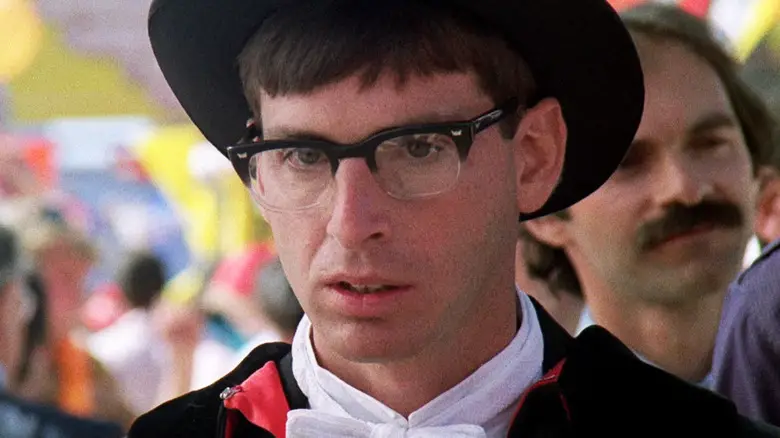Robert Carradine's Lewis Skolnick is seen in closeup as he stands outside in Revenge of the Nerds