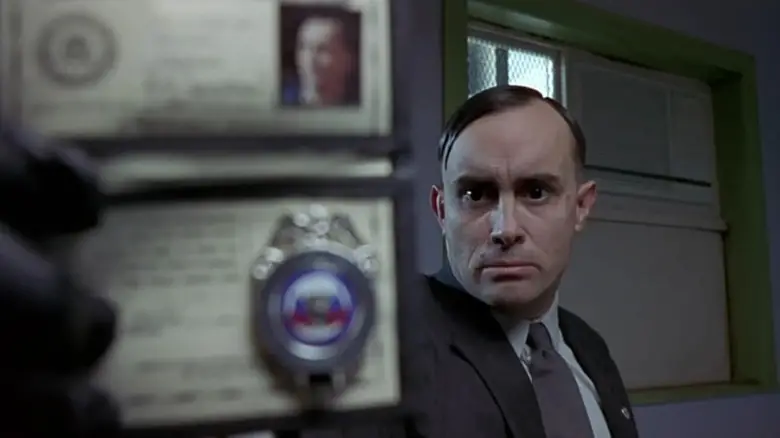 Special Agent Milton Dammers holding up his badge in The Frighteners