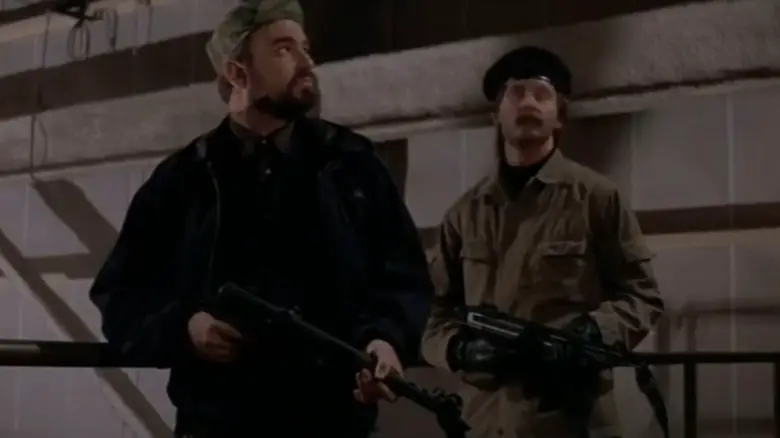 Billy Bob Thornton's Homer Carlton stands holding a rifle in an oil refinery in On Deadly Ground