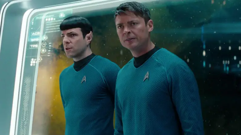Zachary Quinto as Spock standiing next to Karl Urban as Bones in front of a window on the Enterprise in Star Trek: Into Darkness
