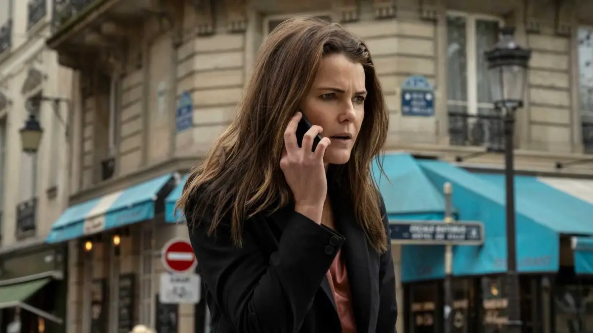 The Diplomat's Kate Wyler standing in the street on the phone, looking shocked and irritated.