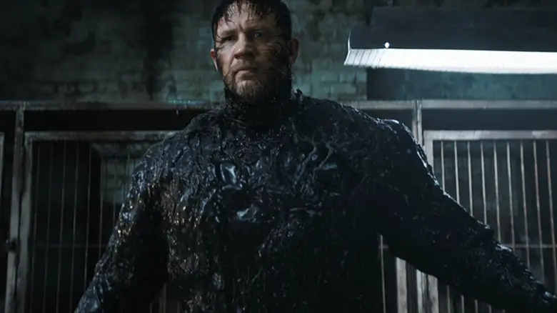 Eddie Brock with the Venom symbiote suit forming around his face in Venom: The Last Dance