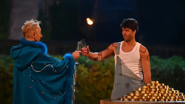 Alan and Rob toasting champagne outside of the castle on The Traitors