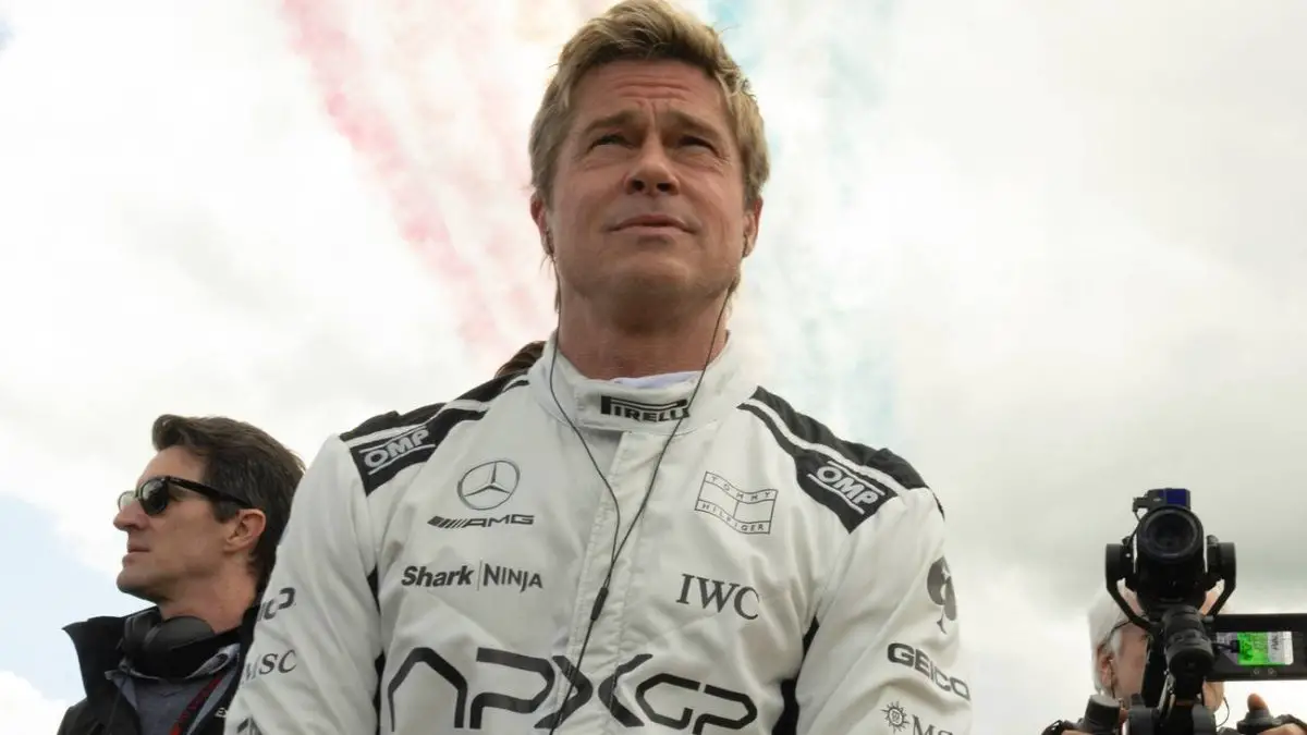 Brad Pitt standing on the set of F1 the Movie