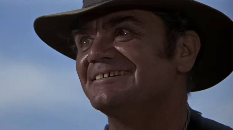 Ernest Borgnine's "Dutch" Engstrom looks into the distance as he stands against a blue sky in The WIld Bunch