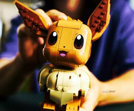 A a vintage-looking edit of an official lifestyle photo of LEGO's first-ever Eevee model. The person holding it is out of focus.