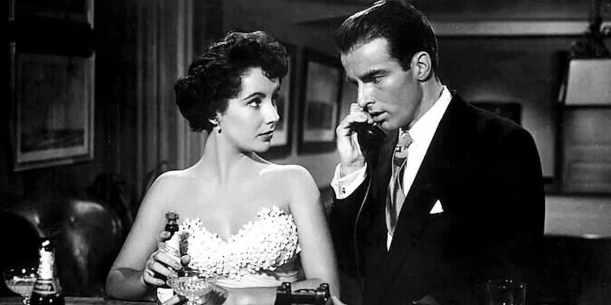 Elizabeth Taylor standing next to Montgomery Clift and looking at him while he's talking on the phone in A Place in the Sun (1951)