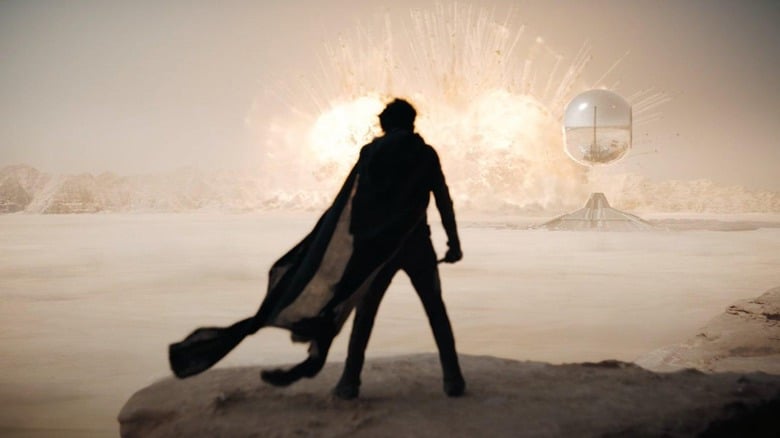 Timothee Chalamet as Paul looking at a big explosion in the distnace in Dune: Part Two