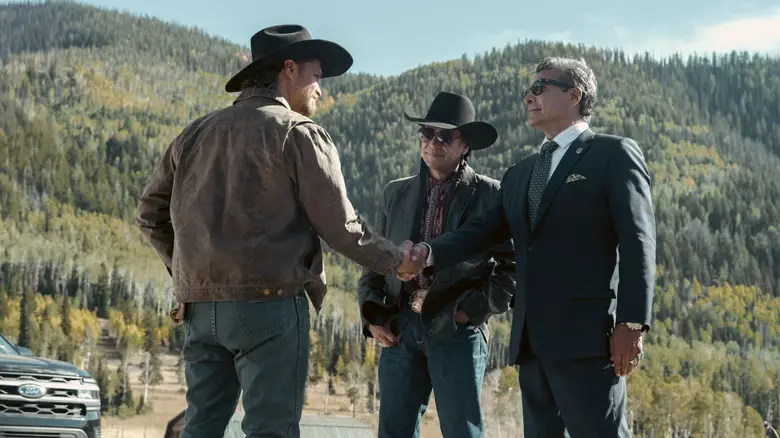 Kayce Dutton (Luke Grimes) shaking hands with Thomas Rainwater (Gil Birmingham) in Marshals
