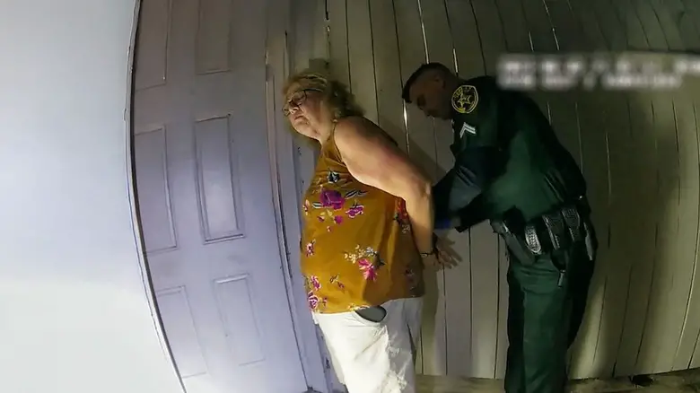 Susan Lorincz is arested at the door of her house in The Perfect Neighbor