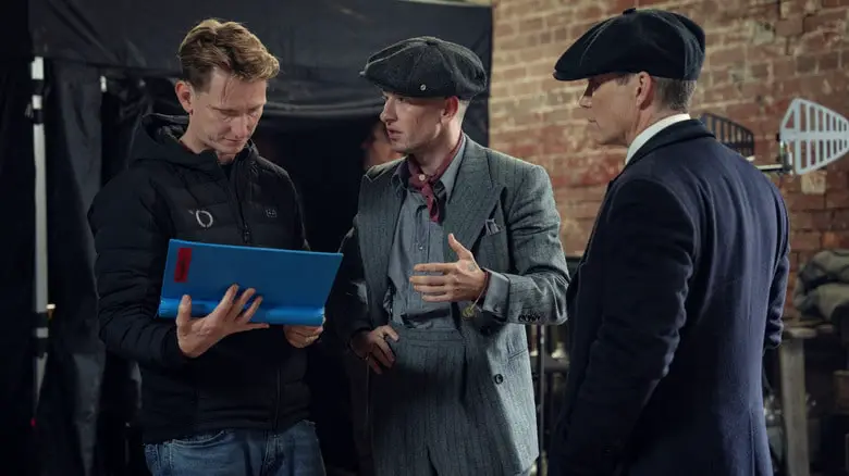 Director Tom Harper talking to actors Barry Keoghan as Duke Shelby and Cillian Murphy as Tommy Shelby on the set of Peaky Blinders: The Immortal Man