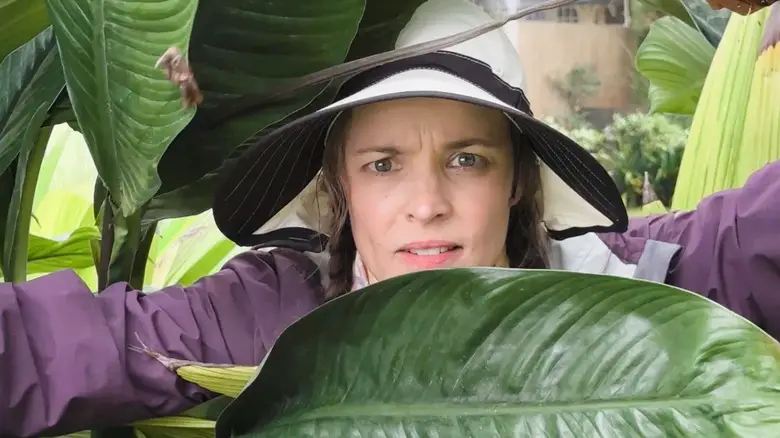 Linda Liddle peering through some leaves in Send Help