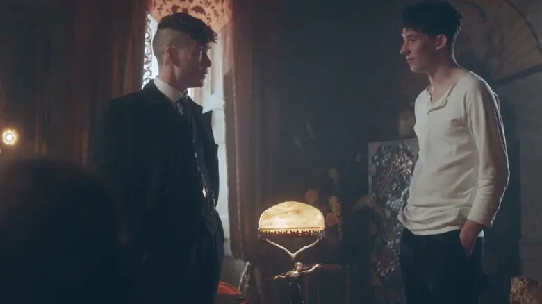 Cillian Murphy as Tommy Shelby standing opposite Josh O'Connor as James in an expensive-looking room in Peaky Blinders