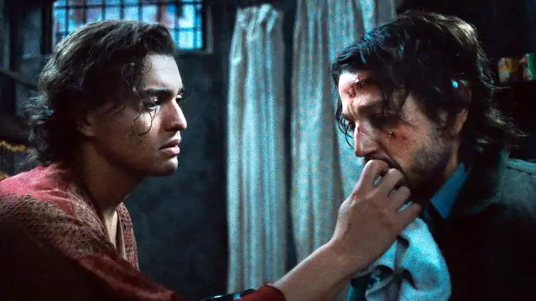 Molina attends to a wounded Valentin in Kiss of the Spider Woman