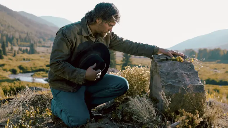 Luke Grimes' Kayce Dutton kneels at his wife's grave in Marshals.jpg
