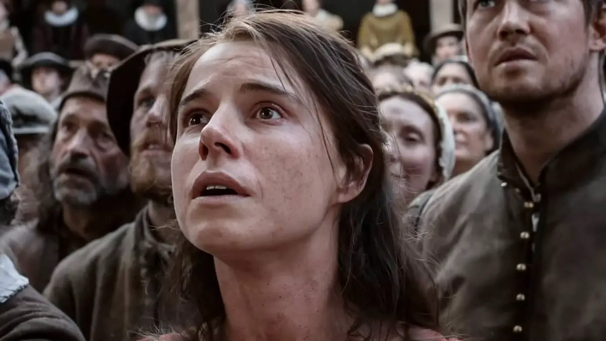 Jessie Buckley and a crowd looking up in awe in Hamnet