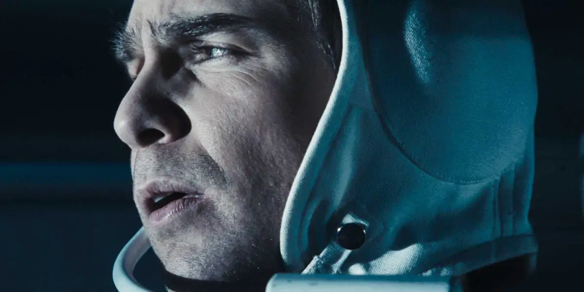 A profile close up of Sam Rockwell as Sam Bell looking to the left in Moon