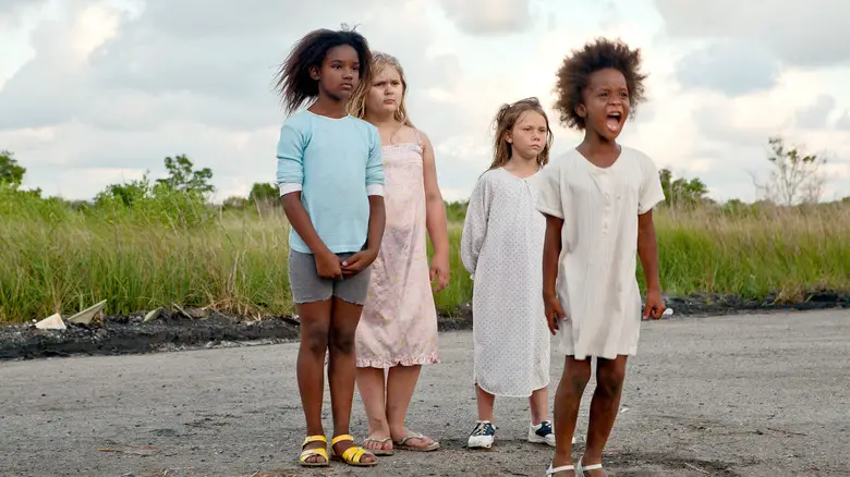 Four girls, led by a yelling Hushpuppy standing in a bare road in Beasts of the Southern Wild