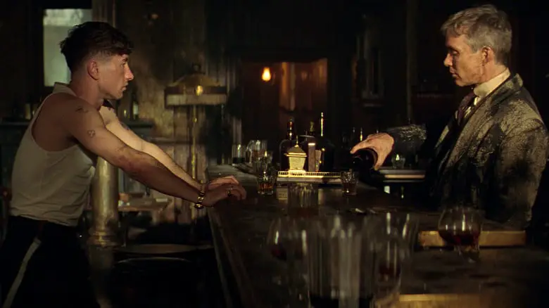 Barry Keoghan as Duke Shelby sharing a drink with Cillian Murphy as Tommy Shelby at a bar in Peaky Blinders: The Immortal Man