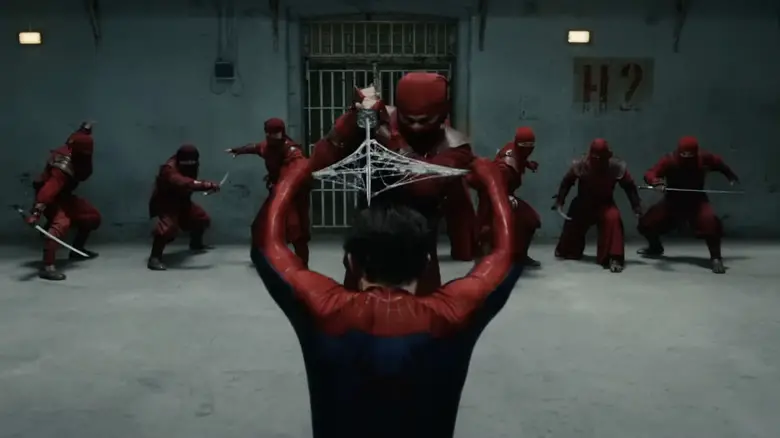 Tom Holland as Spider-Man spins an organic web to block and destroy a sword.