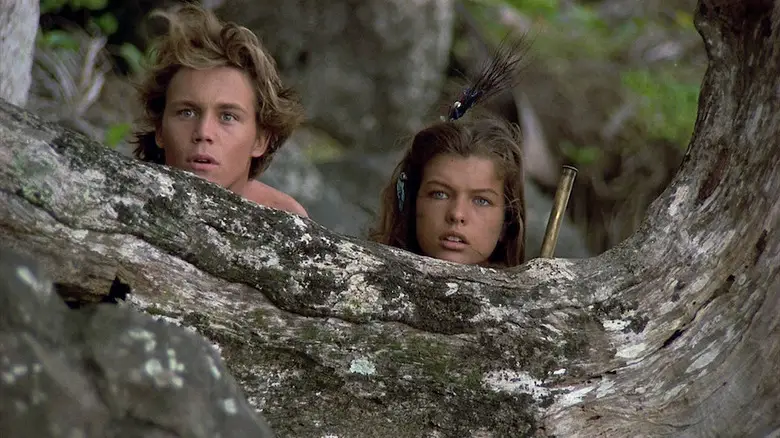 Richard, Jr. and Lilli looking over a log in Return to the Blue Lagoon