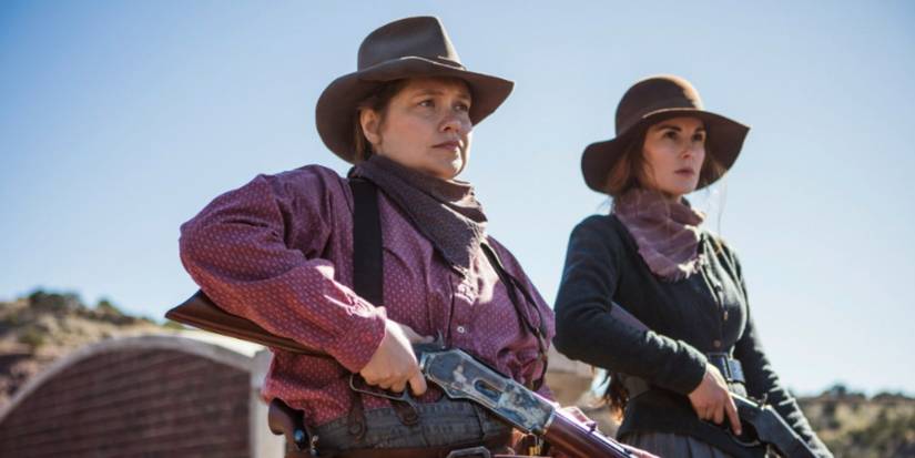 Merritt Wever and Michelle Dockery as Mary Agnes and Alice wearing cowboy hats and holding guns in Godless.