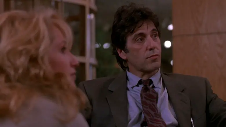 Helen Cruger (Ellen Barkin) and Frank Keller (Al Pacino) look up while seated in Sea of Love