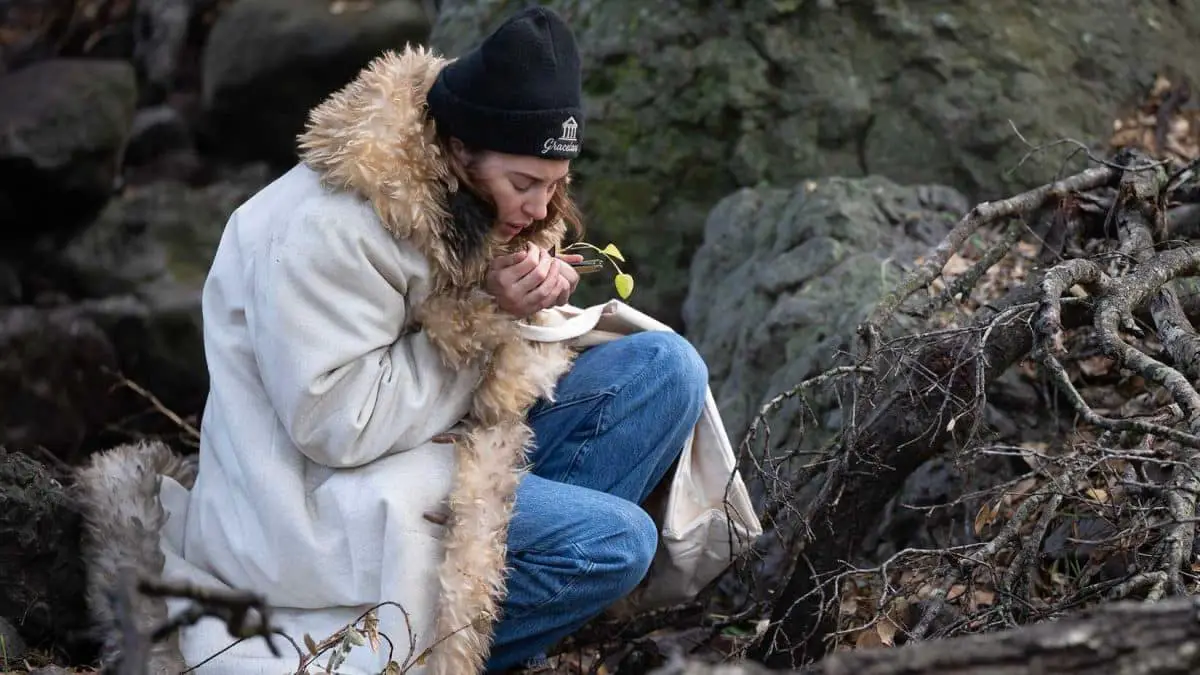 Shailene Woodley as Annie trying to stay warm in the woods in Paradise season 2