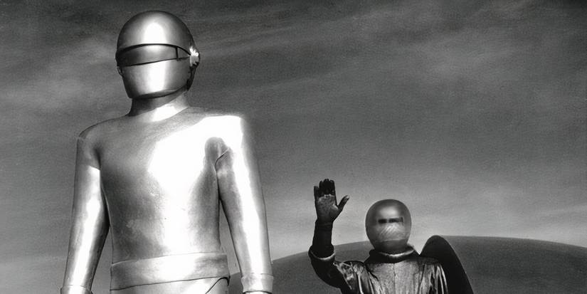 A metallic figure and one in a space uniform stand on a flying saucer in The Day the Earth Stood Still.