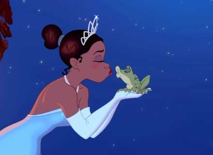 Tiana kisses Frog Naveen on a balcony in The Princess and the Frog.