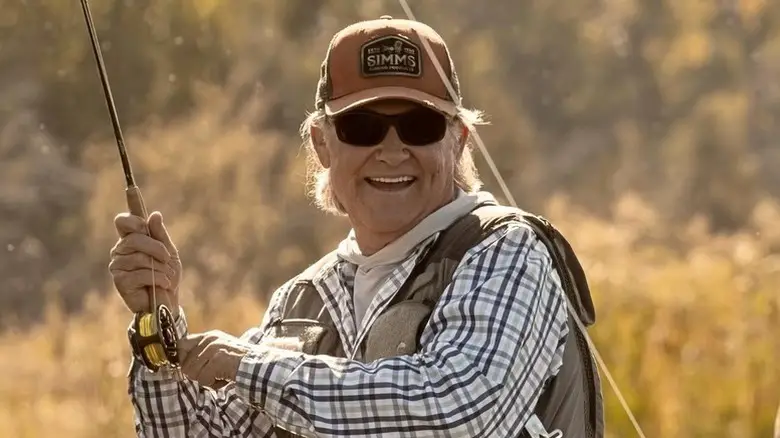 Preston (Kurt Russell) smiling and fishing on "The Madison."
