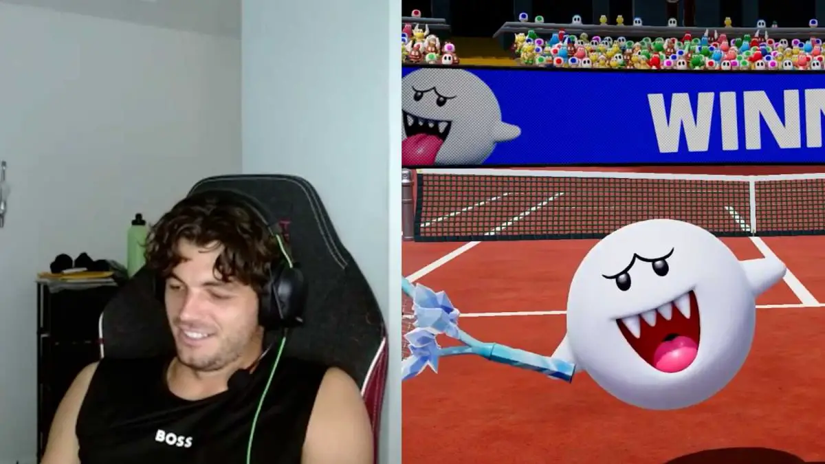 Taylor Fitz smiles down at his Nintendo Switch. The ghost character Boo does a victory pose.