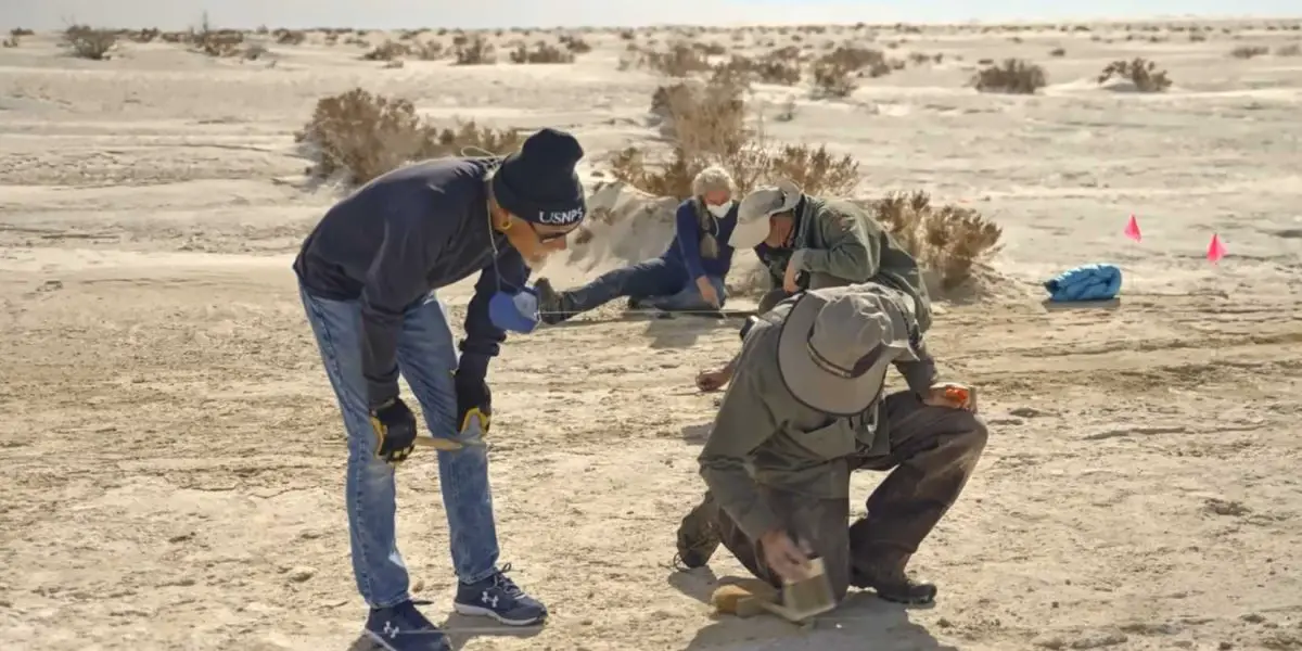 People observing the footprints in the White Sands in Ancient Apocalypse